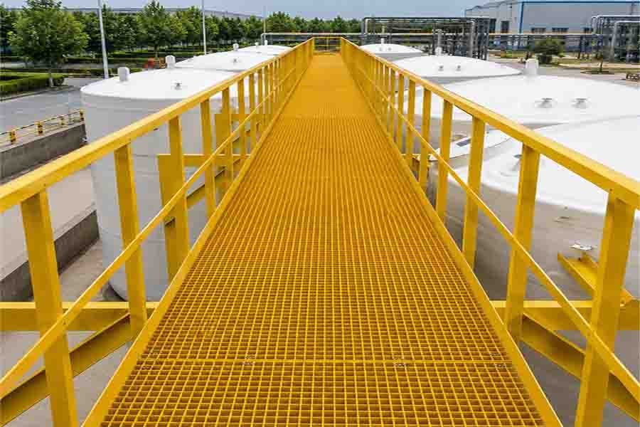 Chemical Plant Walkway Industrial walkway installation utilizing FRP molded grating in a corrosive chemical processing plant environment.